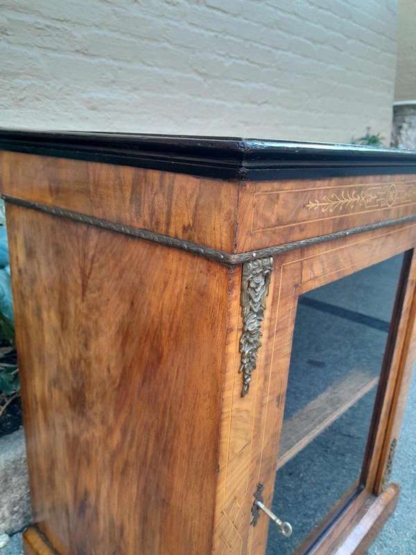 An Antique Victorian Walnut Cabinet with Metal Mounts and Glass Door