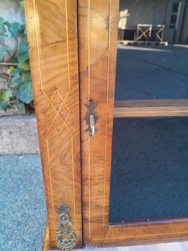 An Antique Victorian Walnut Cabinet with Metal Mounts and Glass Door