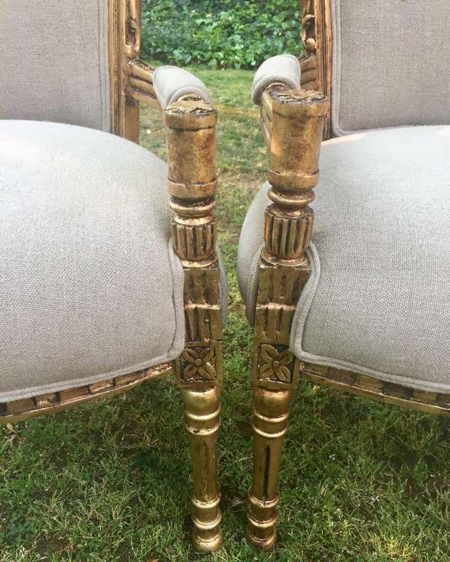 A Pair of French Style Arm Chairs, Hand-Gilded with Gold Leaf and Covered in an Imported Linen
