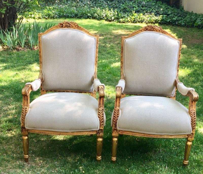 A Pair of French Louis XVI Styled Ornately carved and gilded Fautelli  Chairs in Linen Upholstery
