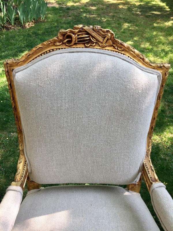 A Pair of French Louis XVI Styled Ornately carved and gilded Fautelli  Chairs in Linen Upholstery