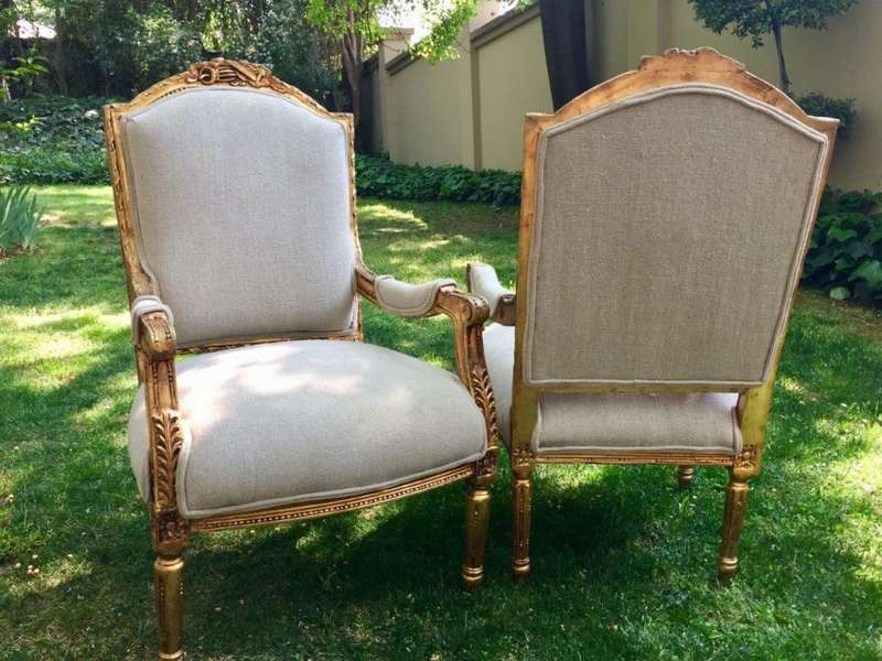 A Pair of French Louis XVI Styled Ornately carved and gilded Fautelli  Chairs in Linen Upholstery