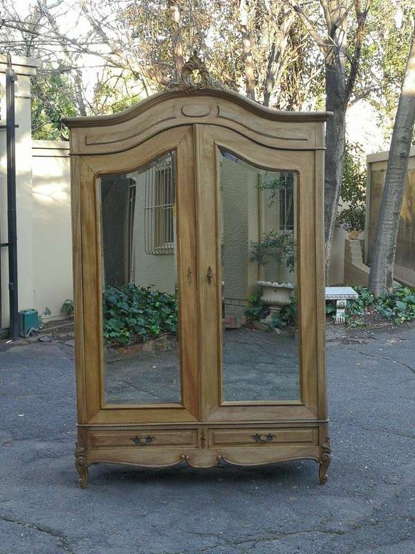 A 20th Century French Rococo Style Armoire with Bevelled Mirrors and Drawers finished in a contem...