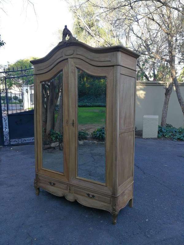 A 20th Century French Rococo Style Armoire with Bevelled Mirrors and Drawers finished in a contem...