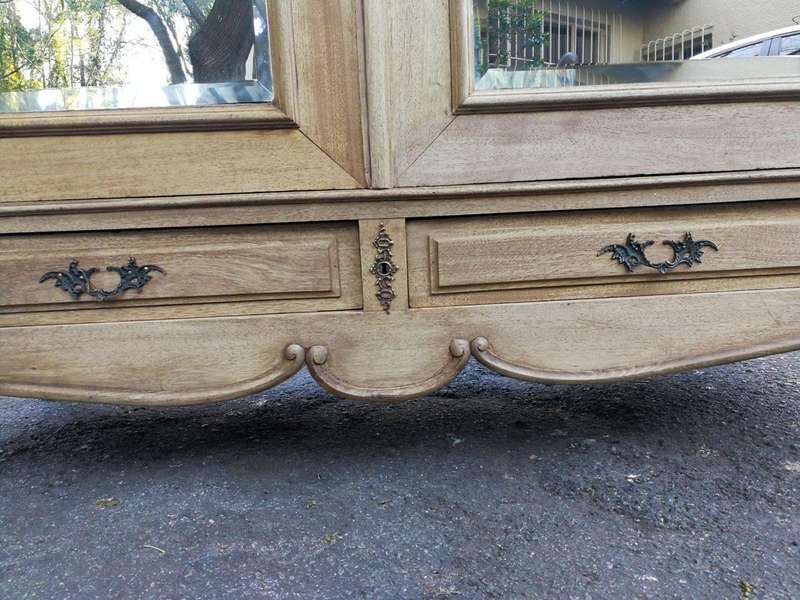 A 20th Century French Rococo Style Armoire with Bevelled Mirrors and Drawers finished in a contem...