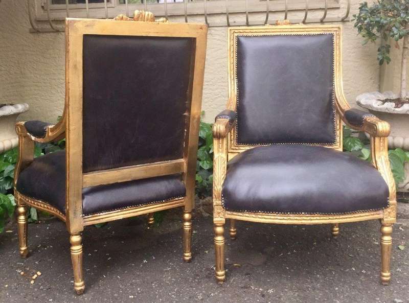 A Pair of French Style Gilded Armchairs Upholstered in Leather