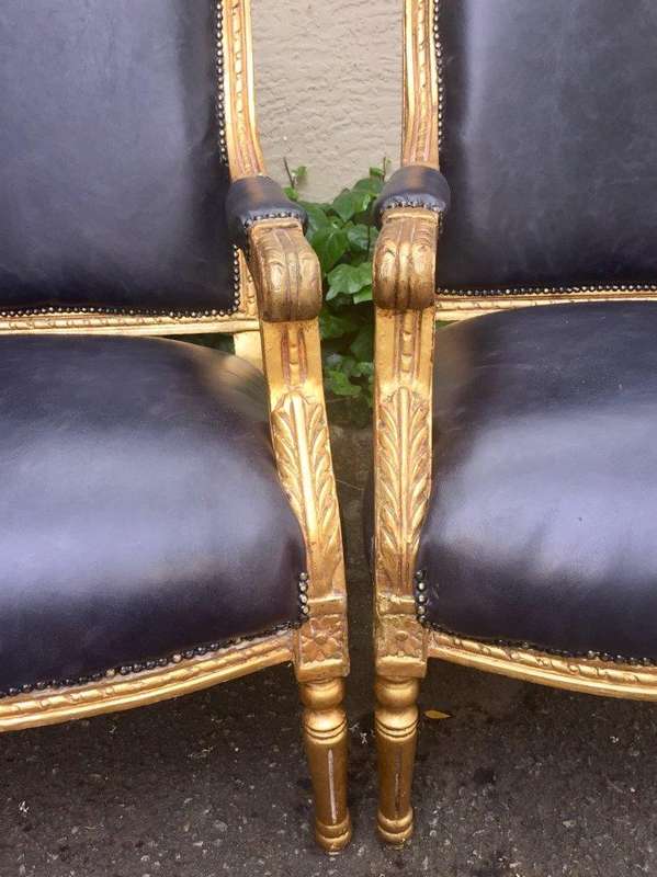 A Pair of French Style Gilded Armchairs Upholstered in Leather
