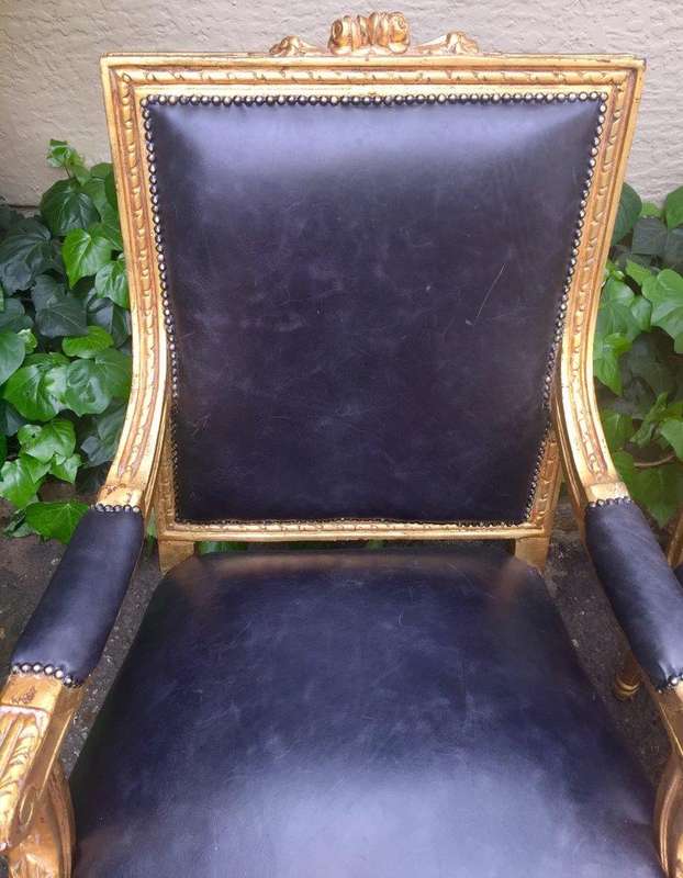 A Pair of French Style Gilded Armchairs Upholstered in Leather