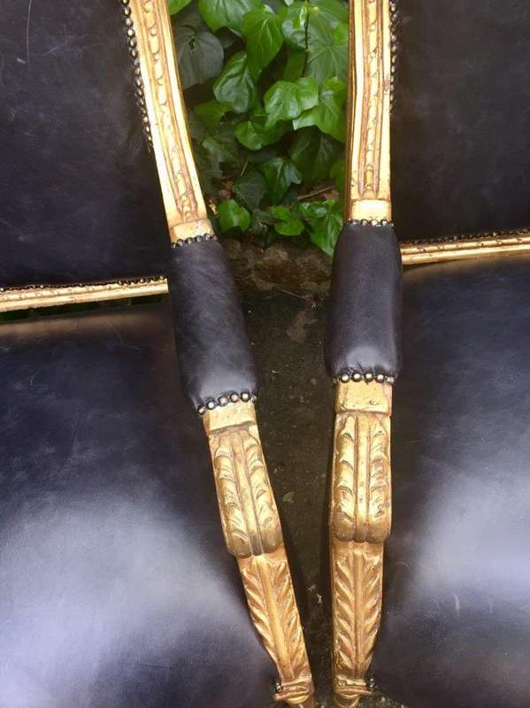 A Pair of French Style Gilded Armchairs Upholstered in Leather