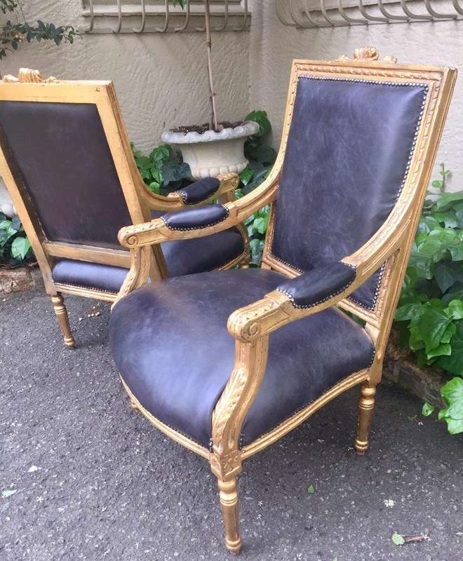A Pair of French Style Gilded Armchairs Upholstered in Leather