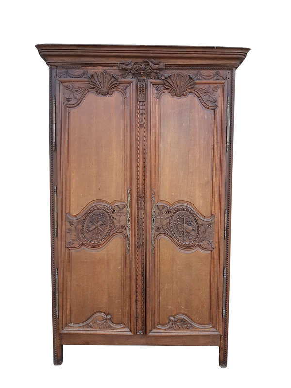 A French Provincial styled Ornately carved Armoire