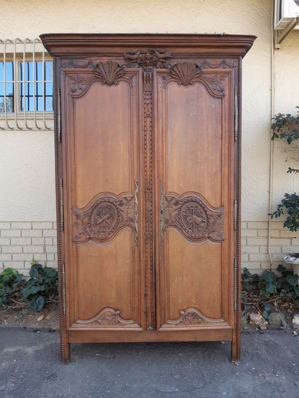 A French Provincial styled Ornately carved Armoire