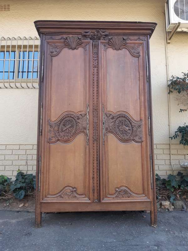 A French Provincial styled Ornately carved Armoire