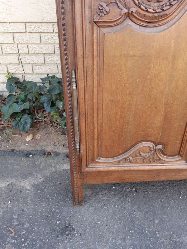 A French Provincial styled Ornately carved Armoire