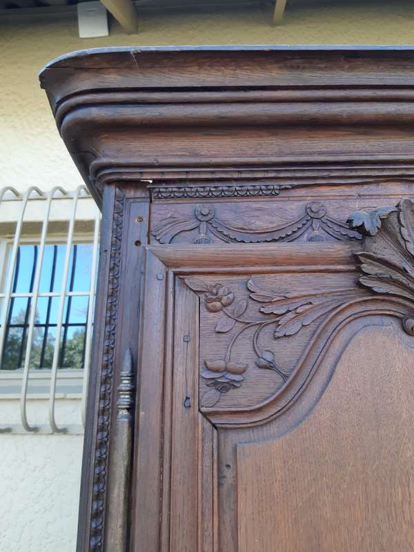 A French Provincial styled Ornately carved Armoire