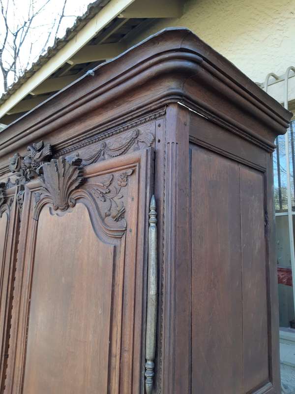 A French Provincial styled Ornately carved Armoire