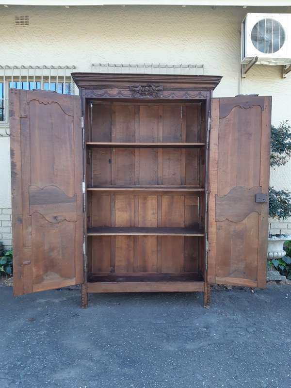 A French Provincial styled Ornately carved Armoire