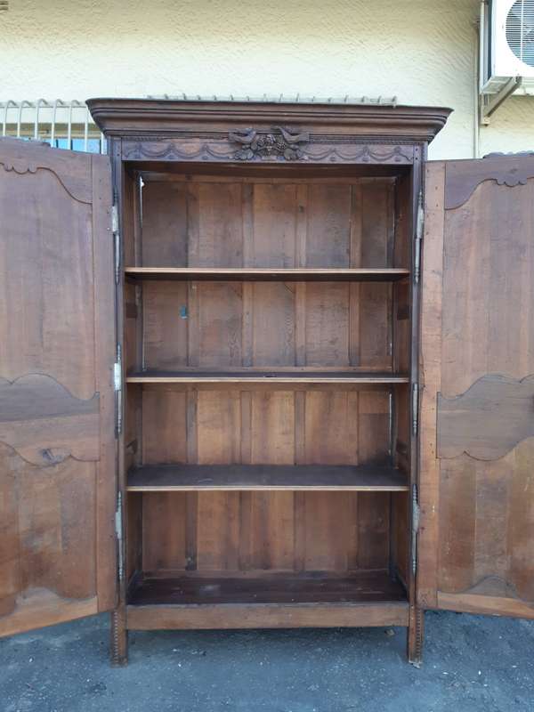 A French Provincial styled Ornately carved Armoire