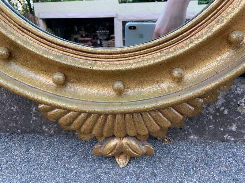 A circular framed 19thC style mirror with eagle crest