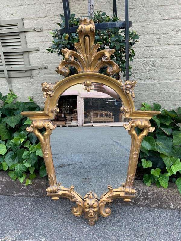 Ornately carved and gilded mirror