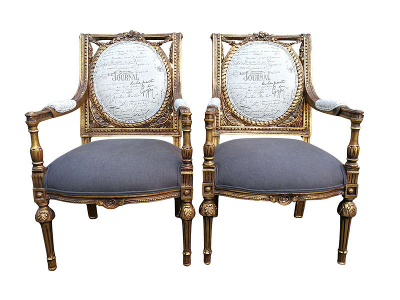An Exceptional Pair of French Style Carved and Gilded Armchairs Upholstered in a Custom-Made Line...