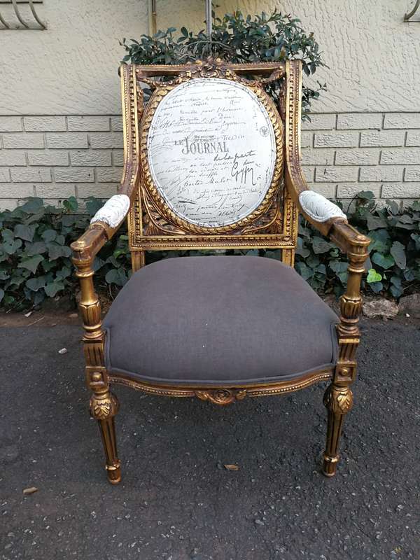 An Exceptional Pair of French Style Carved and Gilded Armchairs Upholstered in a Custom-Made Line...