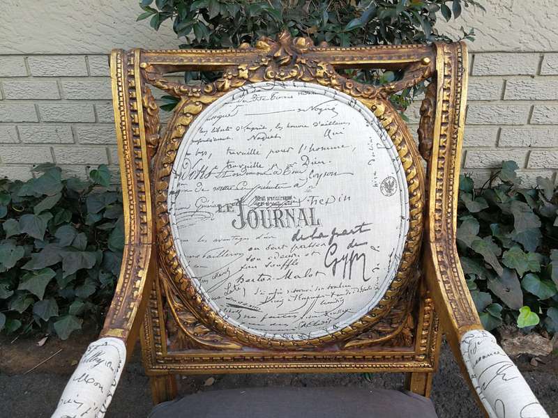 An Exceptional Pair of French Style Carved and Gilded Armchairs Upholstered in a Custom-Made Line...