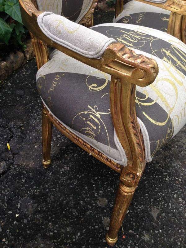 A Pair of French Style Arm Chairs Hand Gilded With Gold Leaf And Upholstered In an Imported Scrip...