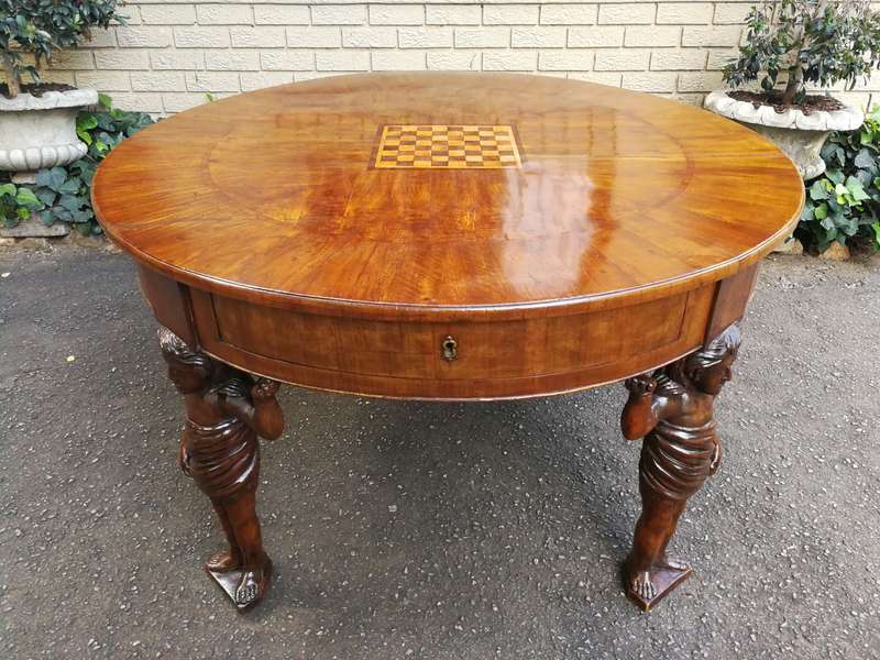 An English Walnut and Rosewood Circular Table With An Inlaid Chess Board And Two Drawers. Circa 1...