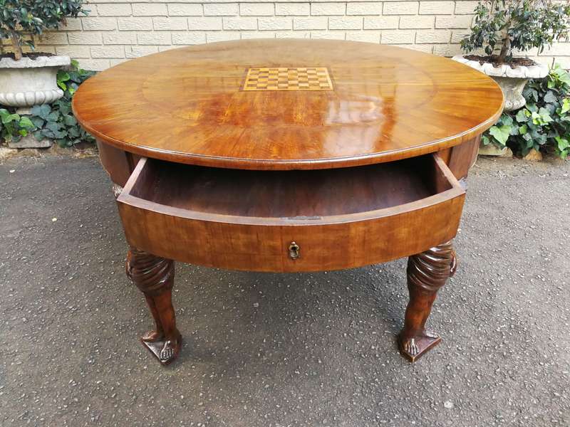 An English Walnut and Rosewood Circular Table With An Inlaid Chess Board And Two Drawers. Circa 1...