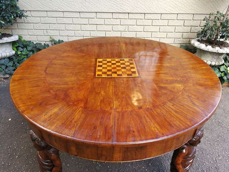 An English Walnut and Rosewood Circular Table With An Inlaid Chess Board And Two Drawers. Circa 1...