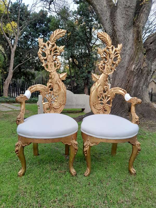 A Pair of Baroque Style Carved and Hand Gilded High Back Throne Chairs (upholstered in white)