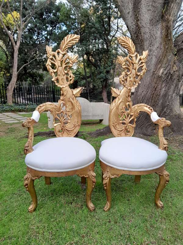 A Pair of Baroque Style Carved and Hand Gilded High Back Throne Chairs (upholstered in white)