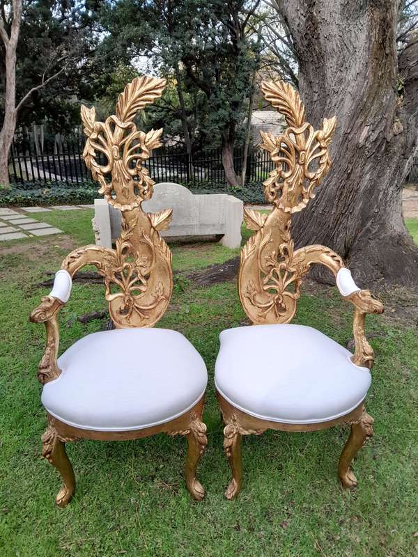 A Pair of Baroque Style Carved and Hand Gilded High Back Throne Chairs (upholstered in white)