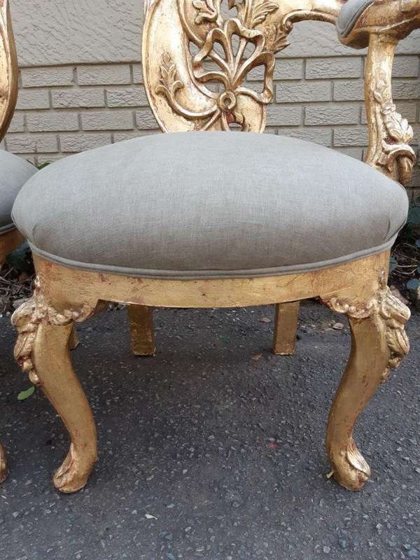 A Pair of Baroque Style Carved and Hand Gilded High Back Throne Chairs (upholstered in linen upho...