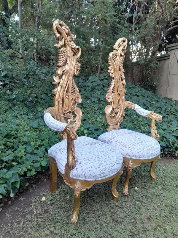 A Pair of Baroque Style Carved and Hand Gilded High Back Throne Chairs (upholstered linen upholst...