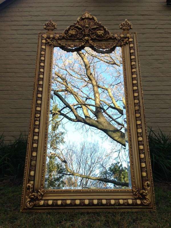 An Ornate Carved Painted Mirror