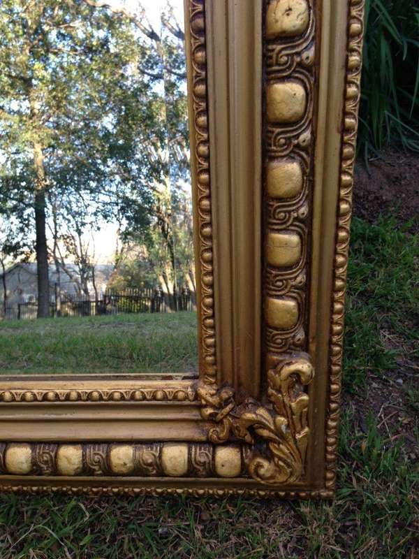 An Ornate Carved Painted Mirror