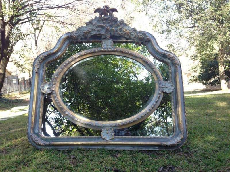 A French Ornate carved painted mirror with a bevelled centre section