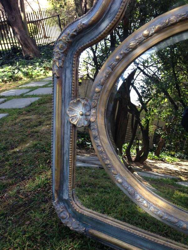 A French Ornate carved painted mirror with a bevelled centre section