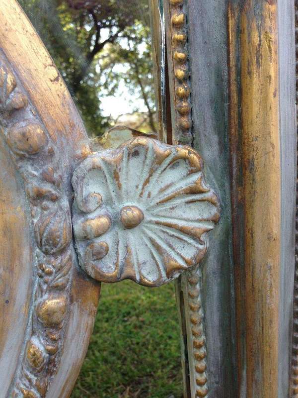 A French Ornate carved painted mirror with a bevelled centre section