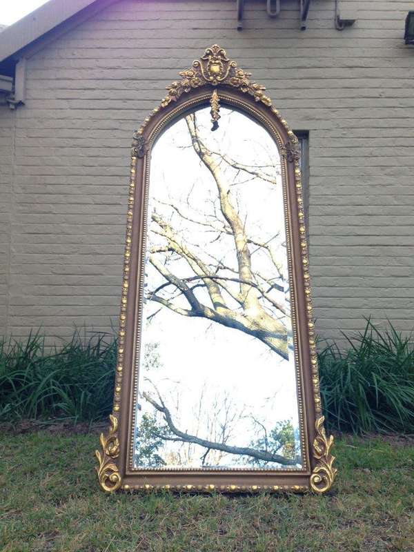 An Ornate Carved Arched Bevelled Mirror