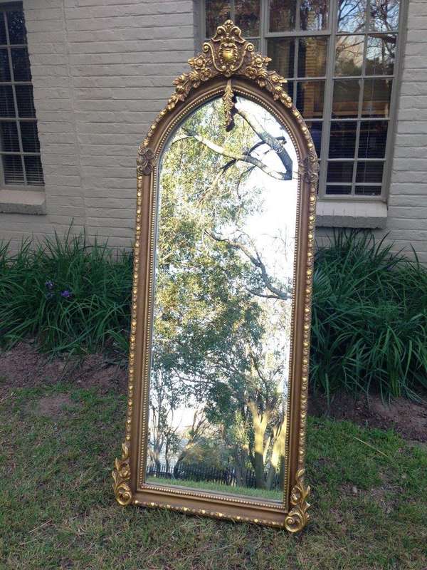 An Ornate Carved Arched Bevelled Mirror