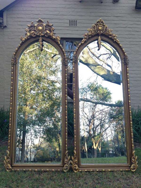 An Ornate Carved Arched Bevelled Mirror