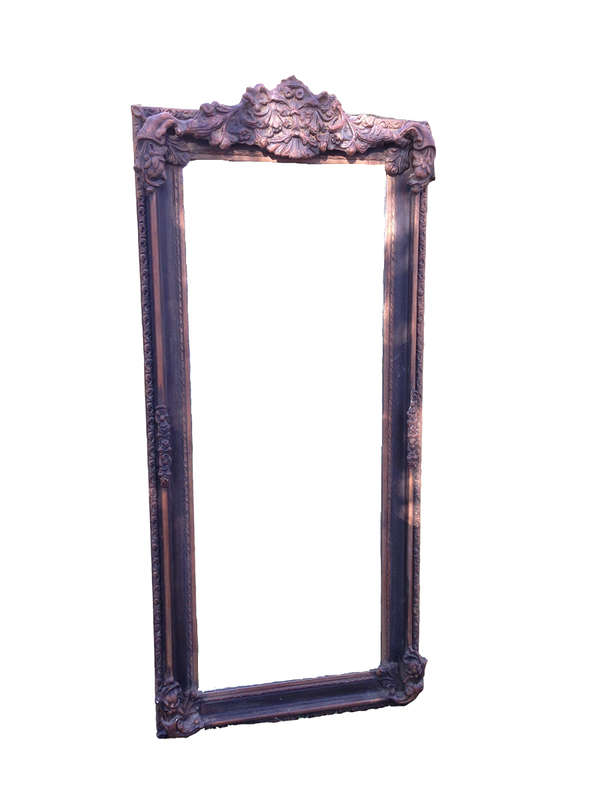 An Ornate Carved Bevelled Mirror