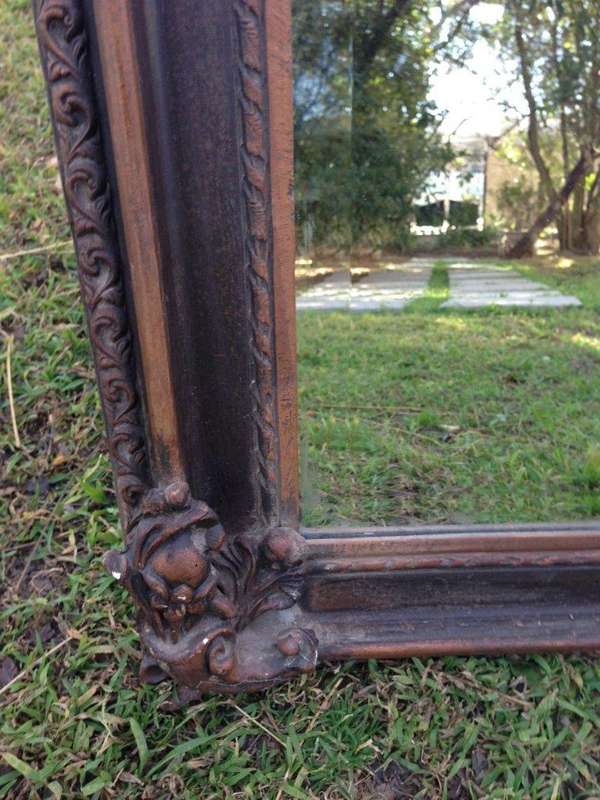 An Ornate Carved Bevelled Mirror