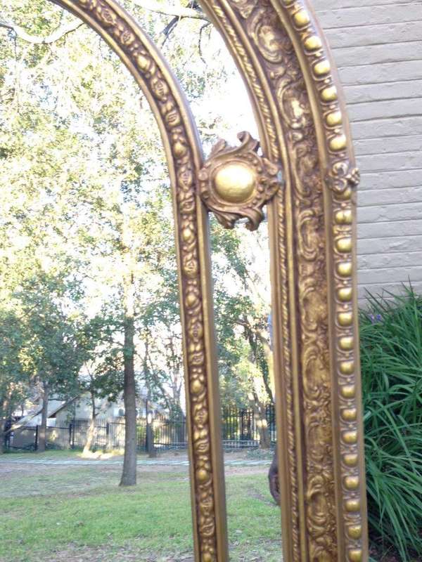 An Ornate Carved Arched Gilded Mirror