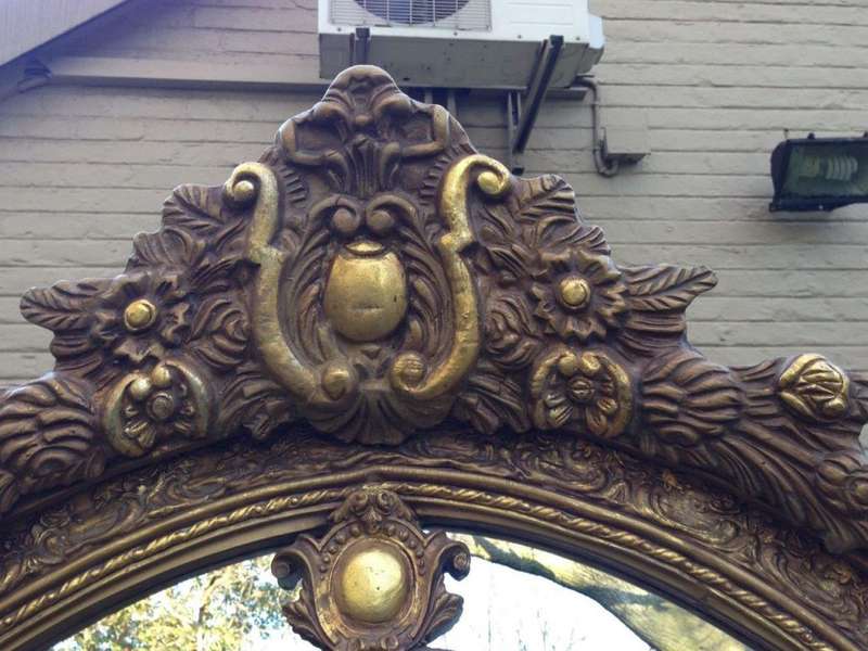 An Ornate Carved Arched Gilded Mirror