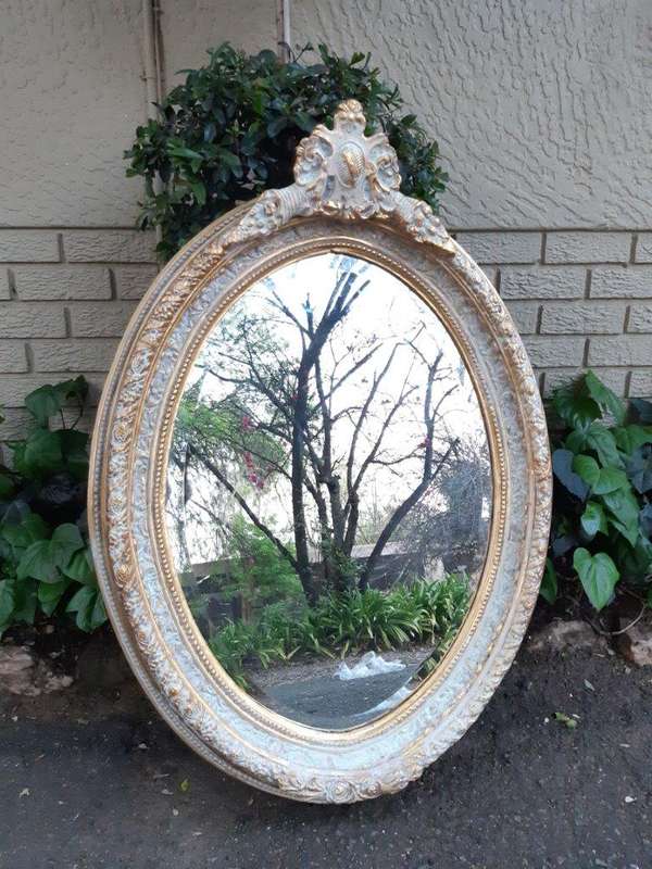 An Oval Ornate Bevelled Mirror