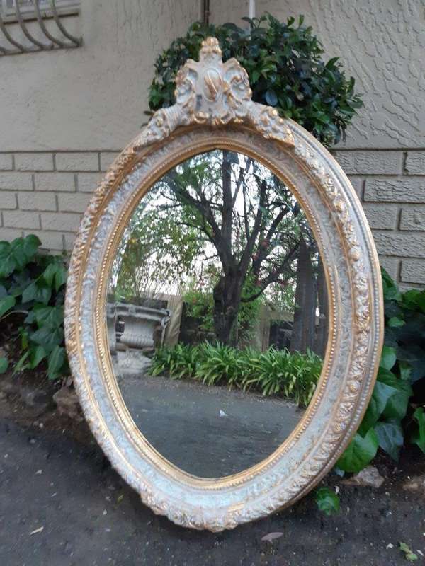 An Oval Ornate Bevelled Mirror